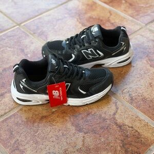Size 7 Men’ And Women’s 8.5 - New Balance Black and White Athletic Shoes